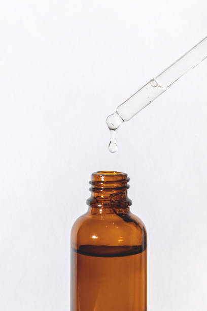 istock Dropping the serum from a pipette into a vial on white 1404271077