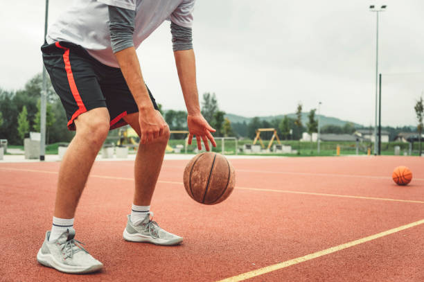 istock Basketball player dribbling basketball 1404272120