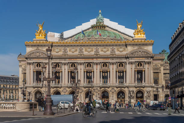 People walking in the Place de l´opera (Opera square) next to the Palais Garnier Opera House (Opera du Paris) at Paris city, France. People walking in the Place de l´opera (Opera square) next to the Palais Garnier Opera House (Opera du Paris) at Paris city, France. Inaugurated in 1875, it is one of the most famous places in Paris. place de lopera stock pictures, royalty-free photos & images