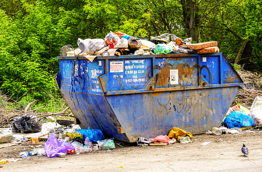 Samara, Russia - May 22, 2022: Containers with garbage and different rubbish at the city street