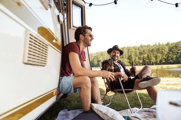 istock Two young male friends spending time on the camper side and drinking beer 1404276641
