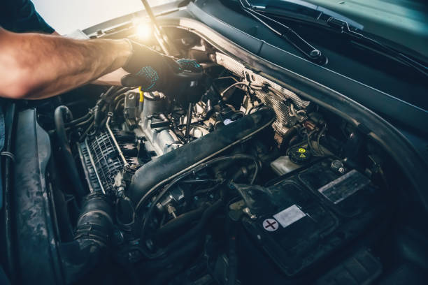 istock Serviceman changes spark plugs in modern turbocharged engine. Timely maintenance and replacement of consumables in car 1404284583