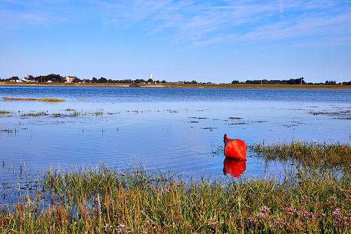 Image of the estuary at Port Bail, France with marker bouy.