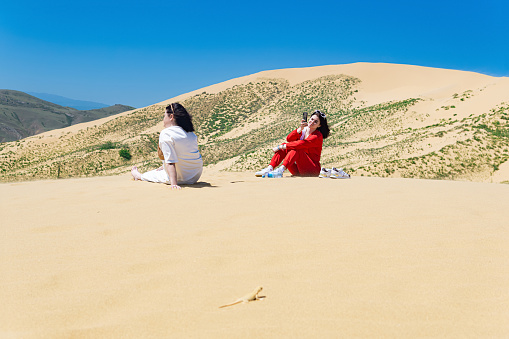 Dagestan, Russia - May 14, 2022: tourists on the slope of the Sarykum sand dune