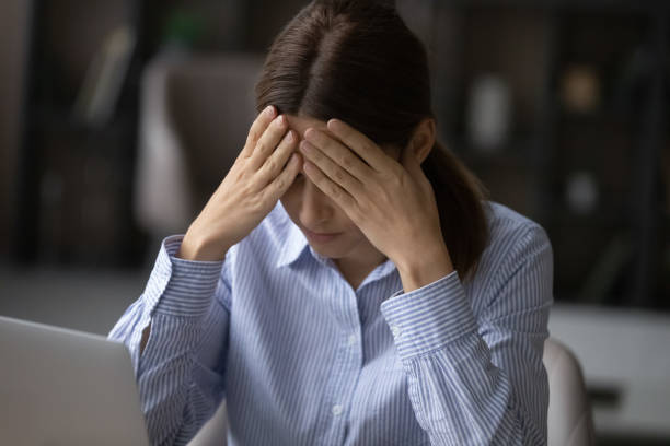 istock Woman sitting near laptop feeling tired or worried about problems 1404288802