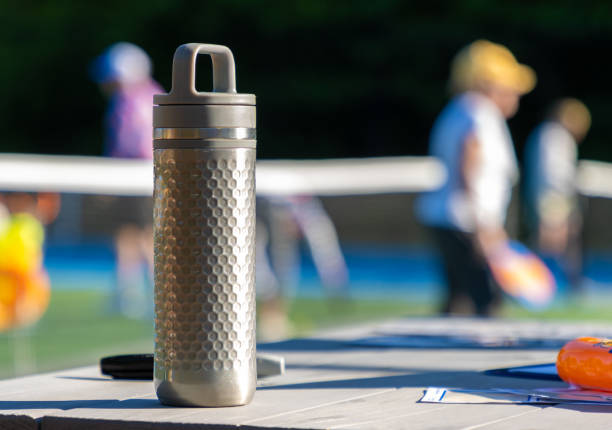 Silver water bottle during summer sports session stock photo