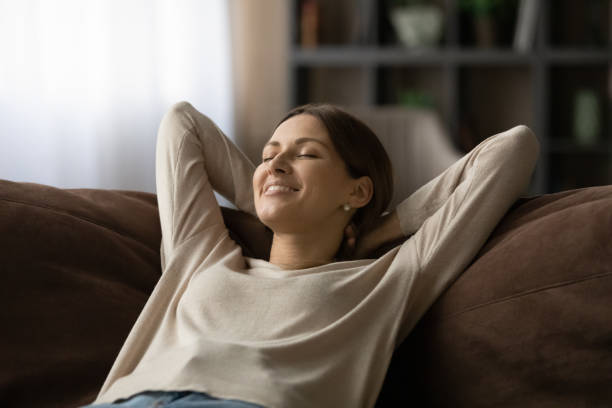 istock Woman lean on sofa closing eyes breath fresh conditioned air 1404289547