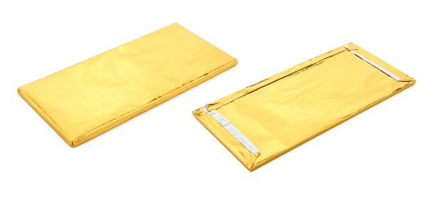 istock Shiny gold chocolate foil package isolated on white background. Two sides 1404289651