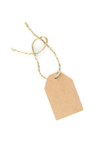 istock Blank cardboard price tag with rope hanging isolated on white background 1404289653