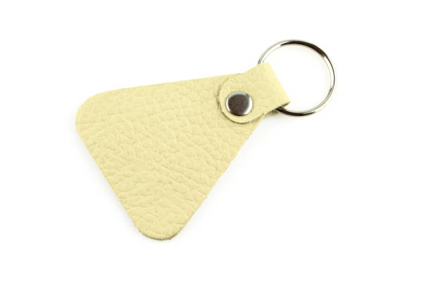 istock Bright leather keyring with silver ring isolated on white background 1404289719