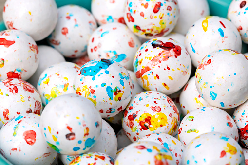 Balls of jawbreaker gum appear paint-splattered
