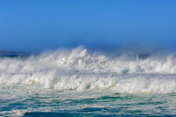 Medium waves crashing on the beach. Salvador city, Bahia state, Brazil.