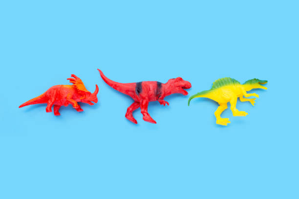 istock Plastic dinosaur toys on blue background. 1404292547