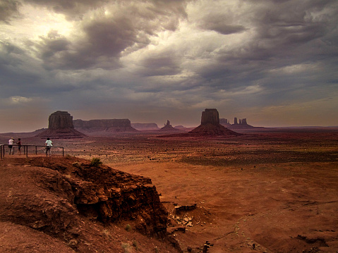 Towering sandstone layer formations, by Navajo Nation's  Monument Valley Navajo Tribal Park in AZ