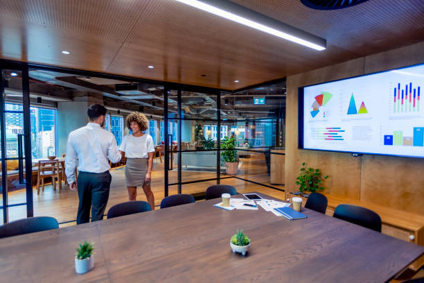 istock Man and woman handshake in a board room. 1404294057