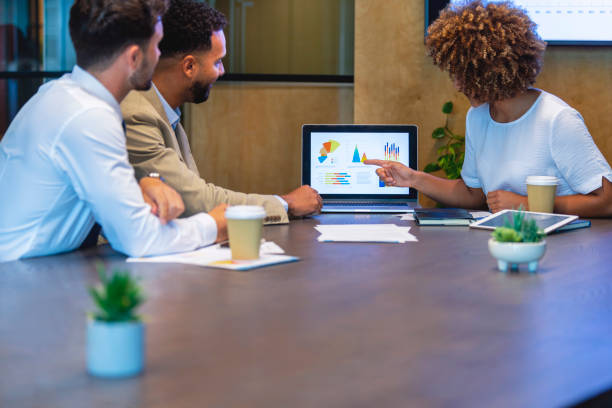 istock Three business people meeting and looking at a laptop 1404294065