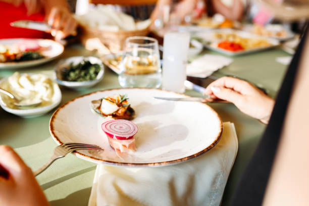 istock Couple Eating Lunch with Fresh Salad and Appetizers 1404296973