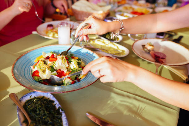 istock Couple Eating Lunch with Fresh Salad and Appetizers 1404297124