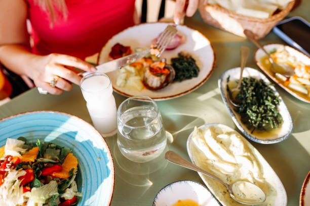 istock Couple Eating Lunch with Fresh Salad and Appetizers 1404297190