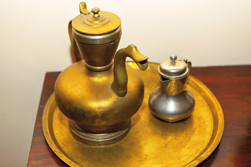 Ancient vessel for boiling water . Golden teapot