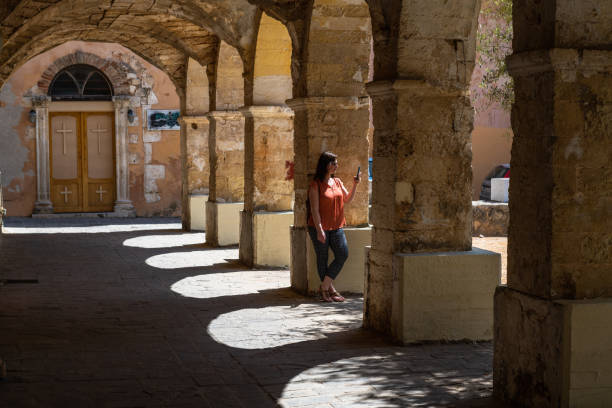 istock Woman relaxes against ancient archway 1404299742