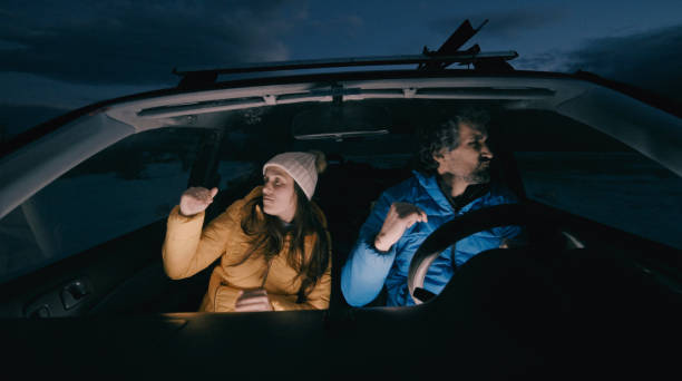 istock Couple on road trip in winter mountain. 1404300510