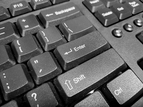 Enter key on a black computer keyboard.