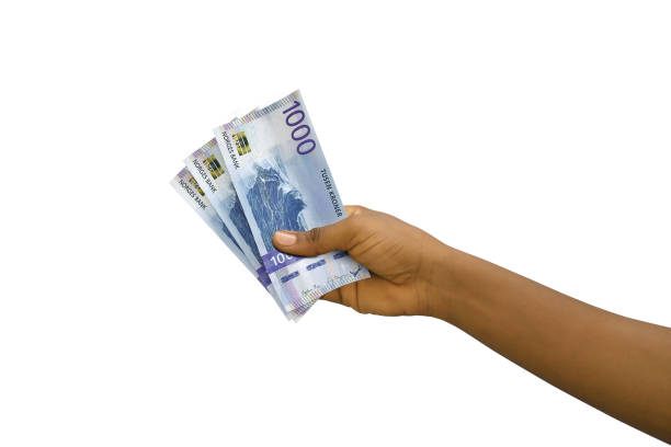 istock Fair hand holding 3D rendered 1000 Norwegian krone notes isolated on white background 1404302351