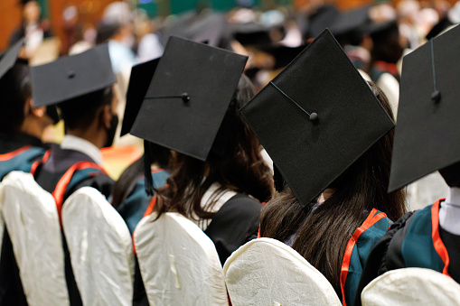 Rear View Of Students Wearing Mortarboards