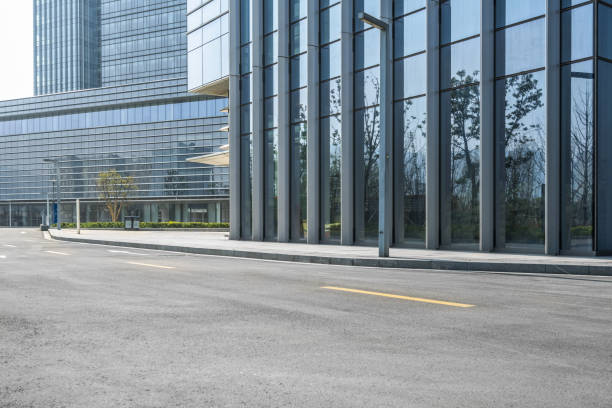 istock empty asphalt road near glass office building 1404310265