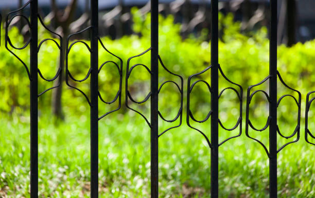 istock Carved cast iron railing, green grass background 1404311156