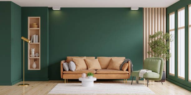 istock Light room with sofa and armchair on empty dark green wall background. 1404316027