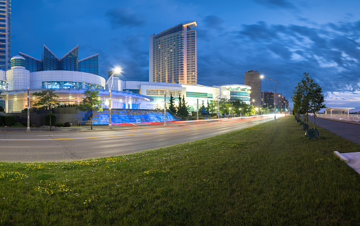 Windsor, Ontario, Canada - June 19, 2022:  The Windsor Ontario skyline at dusk including the futuristic architecture of Caesar's Windsor entertainment complex and casino in the foreground.