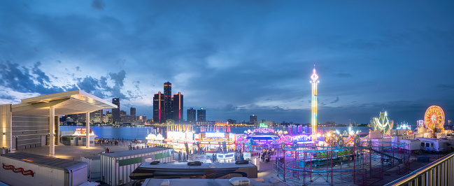 Windsor, Ontario, Canada - June 19, 2022:  The Detroit and Windsor skylines at dusk during Windsor's annual Summerfest celebration event.   The event returns in 2022 after a two year hiatus due to Covid.  This celebration event typically marks the unofficial beginning of summer.