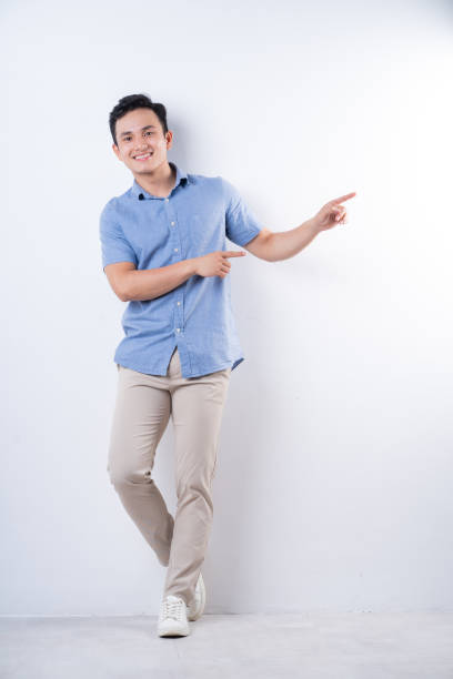 istock Full length image of young Asian man on white background 1404319607