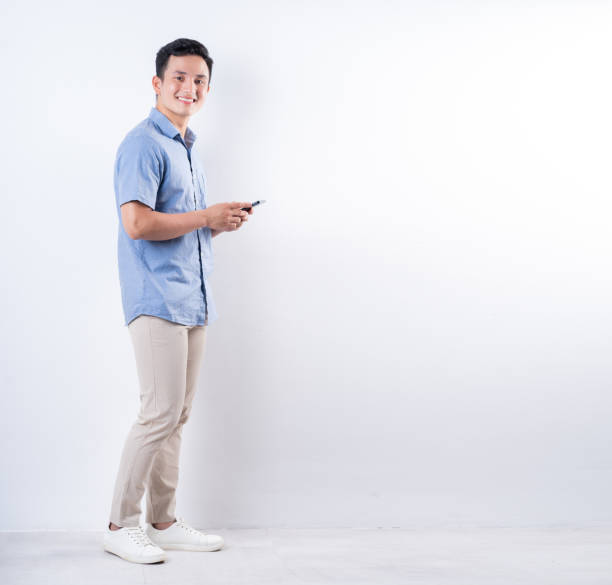 istock Full length image of young Asian man on white background 1404319614