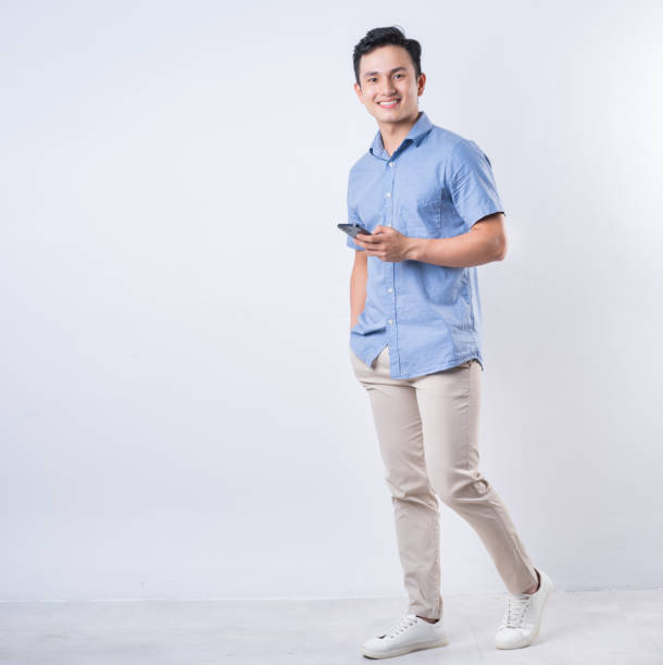 istock Full length image of young Asian man on white background 1404319616