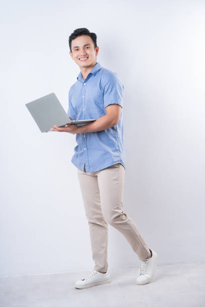 istock Full length image of young Asian man on white background 1404319618
