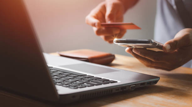 istock Businessman using laptop computer with a credit card making an online order. Business, online shopping, e-commerce, internet banking, spending money, online payment, working from home concept. 1404320356