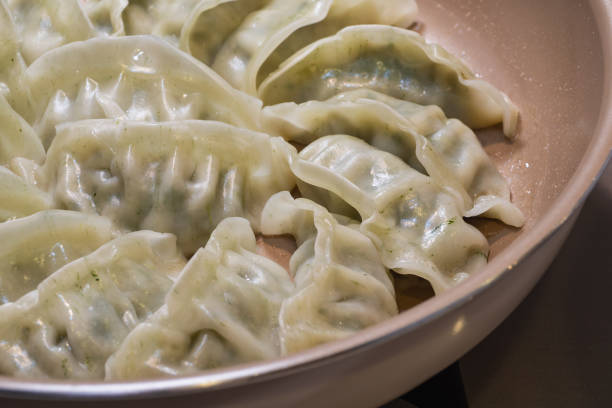 istock Japanese grilled gyoza being cooked. 1404321883