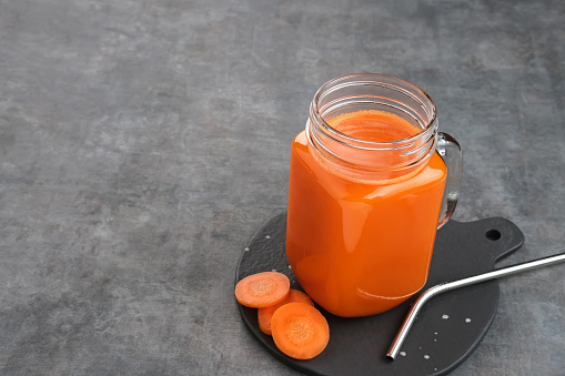 A glass of fresh carrot juice, very good for health. Cold pressed juice