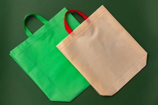 istock Textile shopping bag on green background flat lay 1404327128