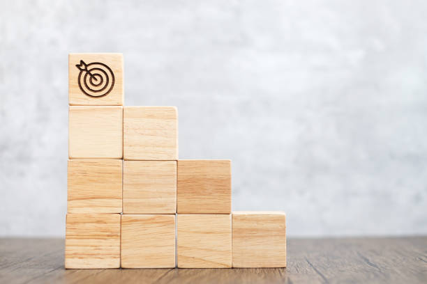 istock dartboard block over stack of building with business goal, strategy, target, mission, action, objective, aim and success concept 1404329079
