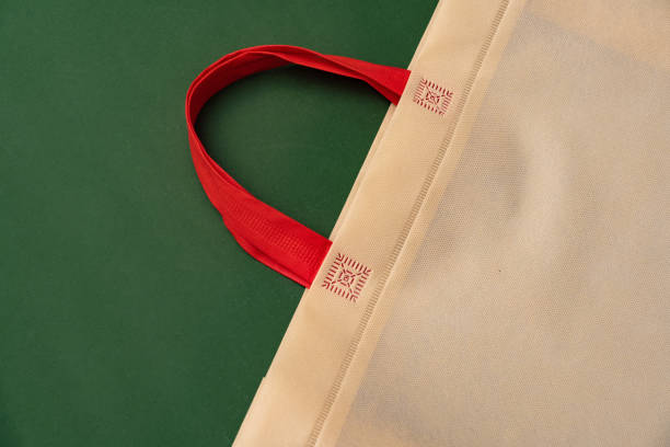 istock Textile shopping bag on green background flat lay 1404330083