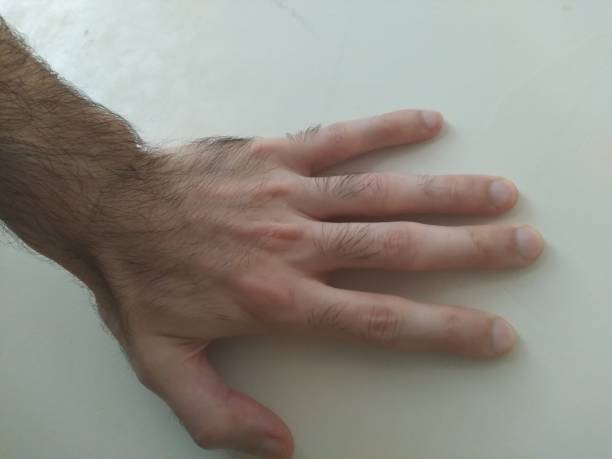 istock male hand fingers light color background 1404330494