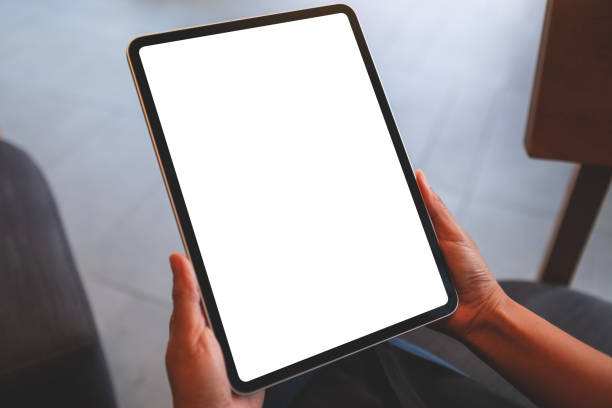 istock Mockup image of a woman holding digital tablet with blank white desktop screen 1404331482