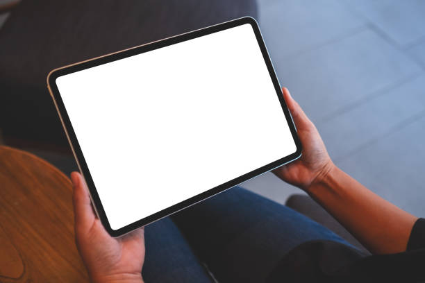 istock Mockup image of a woman holding digital tablet with blank white desktop screen 1404331483