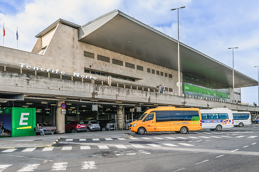 Tenerife, Spain - November 24, 2021: Bus stop outside Tenerife Norte Airport in the Canary Islands. Modern airport terminal building - outside view