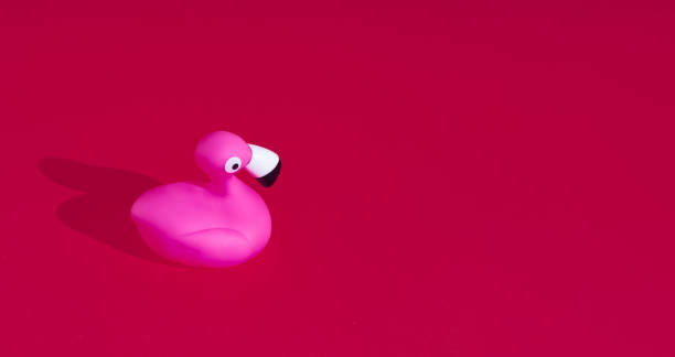 istock Plastic pink flamingo on crimson red background 1404334727