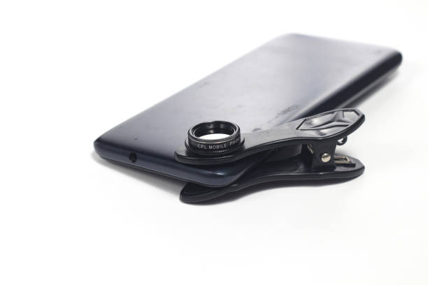 istock Photo Additional Lens CPL Filter attached to Smartphone for photography at white background 1404336073